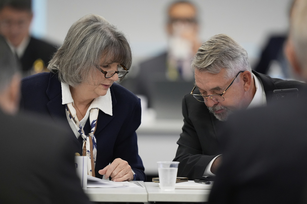 Committee members, Dr. Joseph Hibbeln, right, talks with Vicky Pebsworth, left, during a meeting of the Advisory Committee on Immunization Practices at the CDC on Thursday, Sept. 18, 2025, in Chamblee, Ga. (AP Photo/Brynn Anderson)