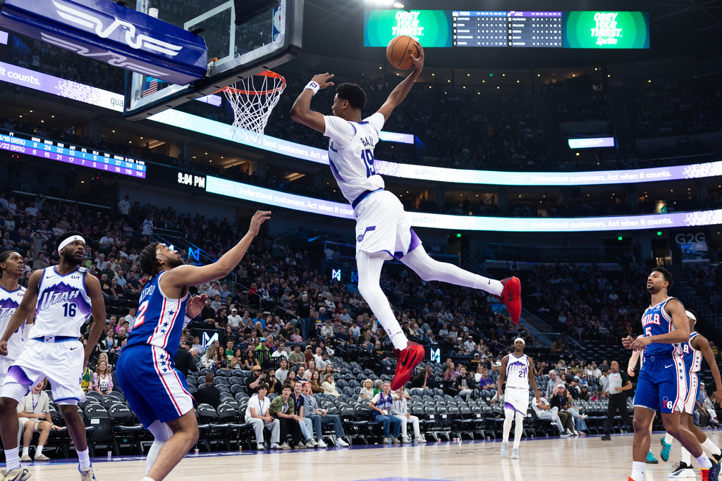 Utah Jazz forward Ace Bailey (19) goes up to dunk over Philadelphia 76ers forward Trendon Watford, third from left, during the second half of an NBA basketball game, Saturday, March 21, 2026, in Salt Lake City. (AP Photo/Anna Fuder)