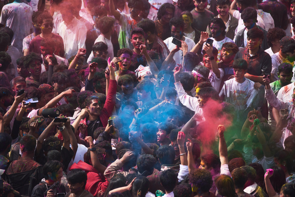 Nepalese people throw colored powders on each other as they celebrate Holi, the Hindu festival of colors at Basantapur Durbar Square in Kathmandu, Nepal, Monday, March 2, 2026. (AP Photo/Niranjan Shrestha)
