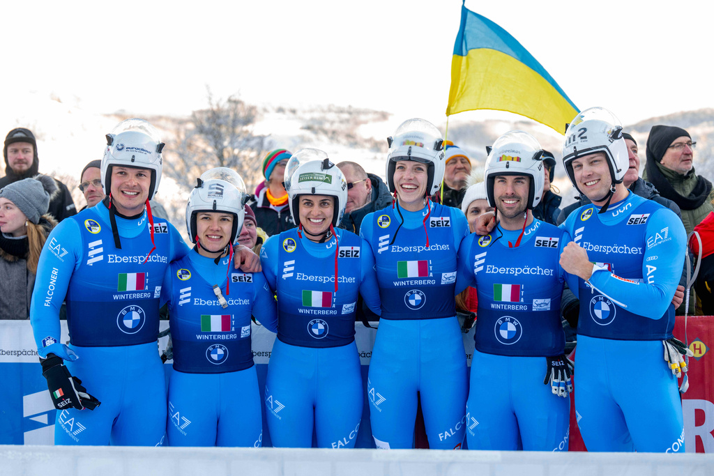 The Italian relay team with Verena Hofer, Ivan Nagler, Fabian Malleier, Dominik Fischnaller, Andrea Voetter and Marion Oberhofer celebrate their third place at the mixed relay competition of the Luge World Cup in Winterberg, Germany, Sunday Jan. 11, 2026. (David Inderlied/dpa via AP)