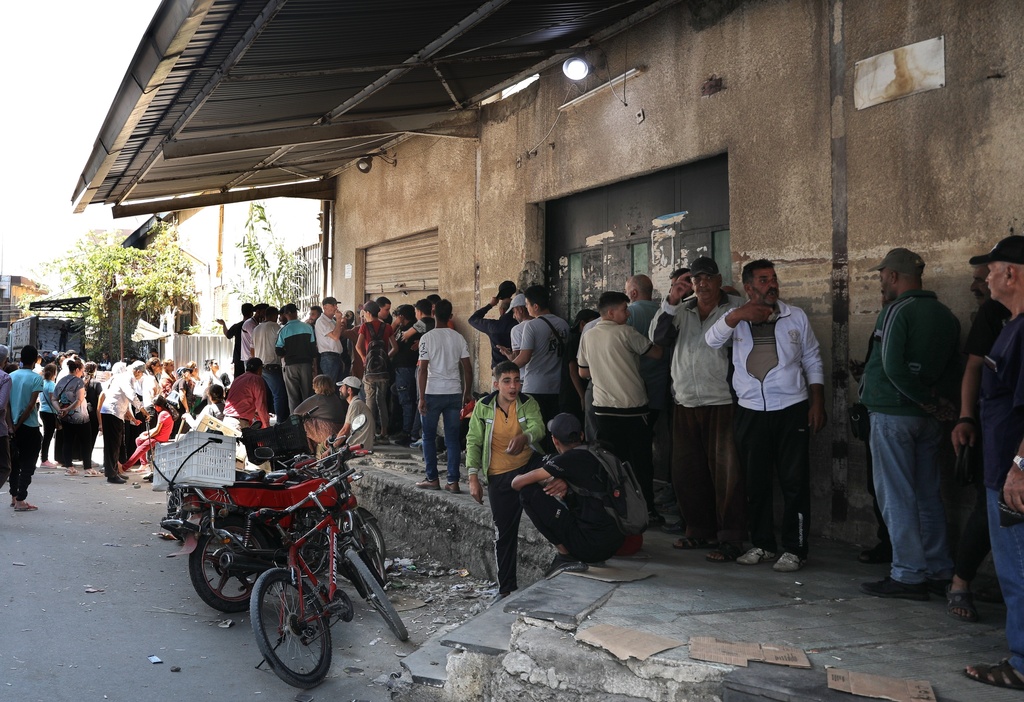 People line up for bread outside a bakery in Sweida, southern Syria, on Sept. 18, 2025.(AP Photo/Fahd Kiwan)