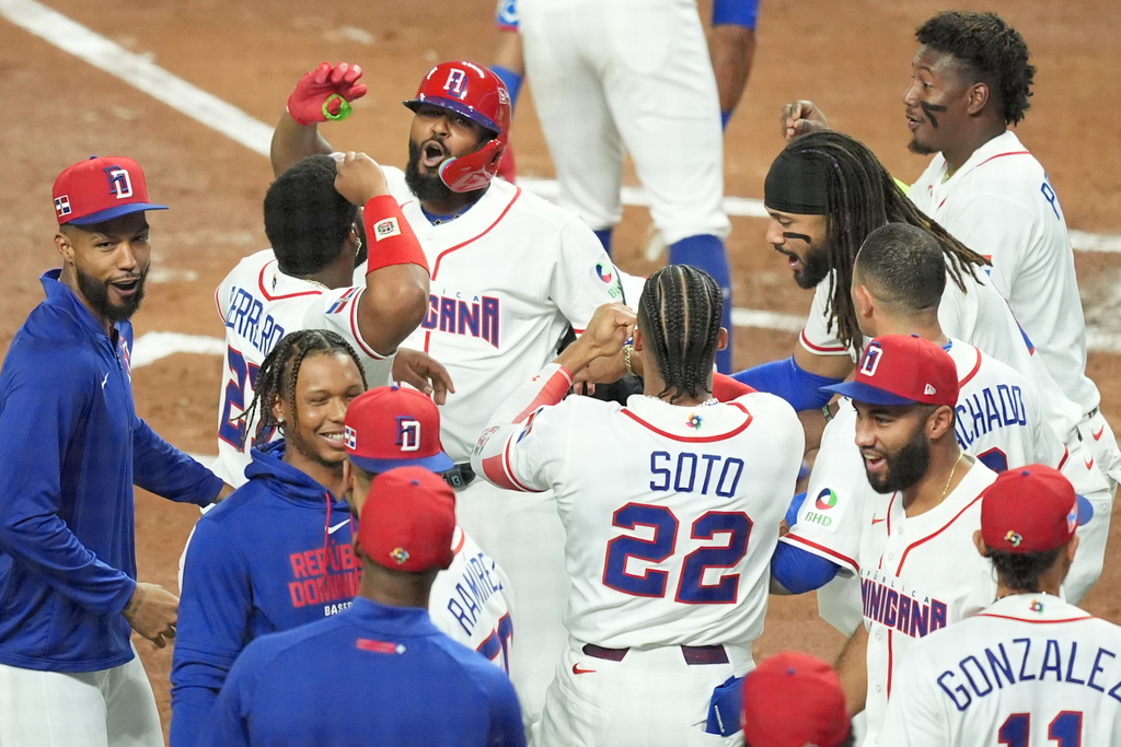 Dominican Republic's Junior Caminero celebrates his home run during the second inning of a World Baseball Classic semifinal game against the United States, Sunday, March 15, 2026, in Miami. (AP Photo/Rebecca Blackwell)