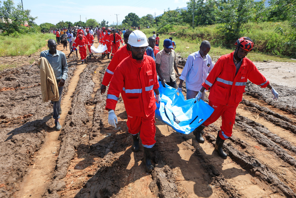 Rescue teams carry bodies of victims of a landslide in the hilly area of Chesongoch in Elgeyo Marakwet county, western Kenya, Sunday, Nov. 2, 2025. (AP Photo/Andrew Kasuku)