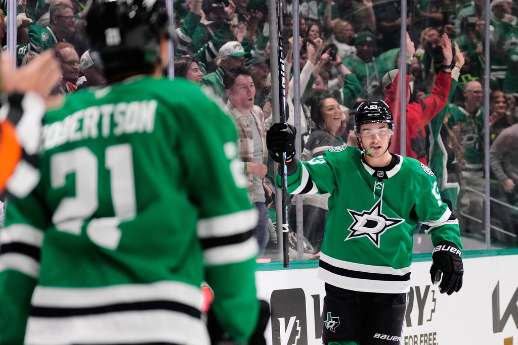 Dallas Stars' Wyatt Johnston (53) and Jason Robertson celebrate Johnston's goal in the first period of an NHL hockey game against the Seattle Kraken in Dallas, Wednesday, Feb. 25, 2026. (AP Photo/Tony Gutierrez)