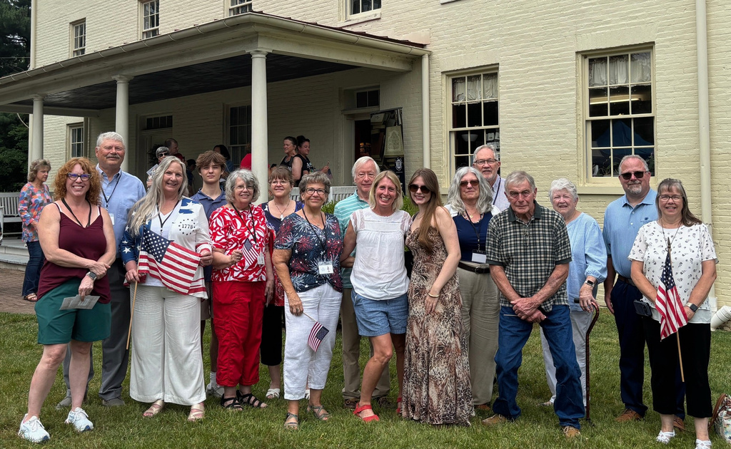 Relatives of Revolutionary War Pvt. John Pumphrey pose for a photo outside the 19th century Benson-Hammond House in Linthicum Heights, Md., on June 18, 2026. (FHD Forensics via AP)