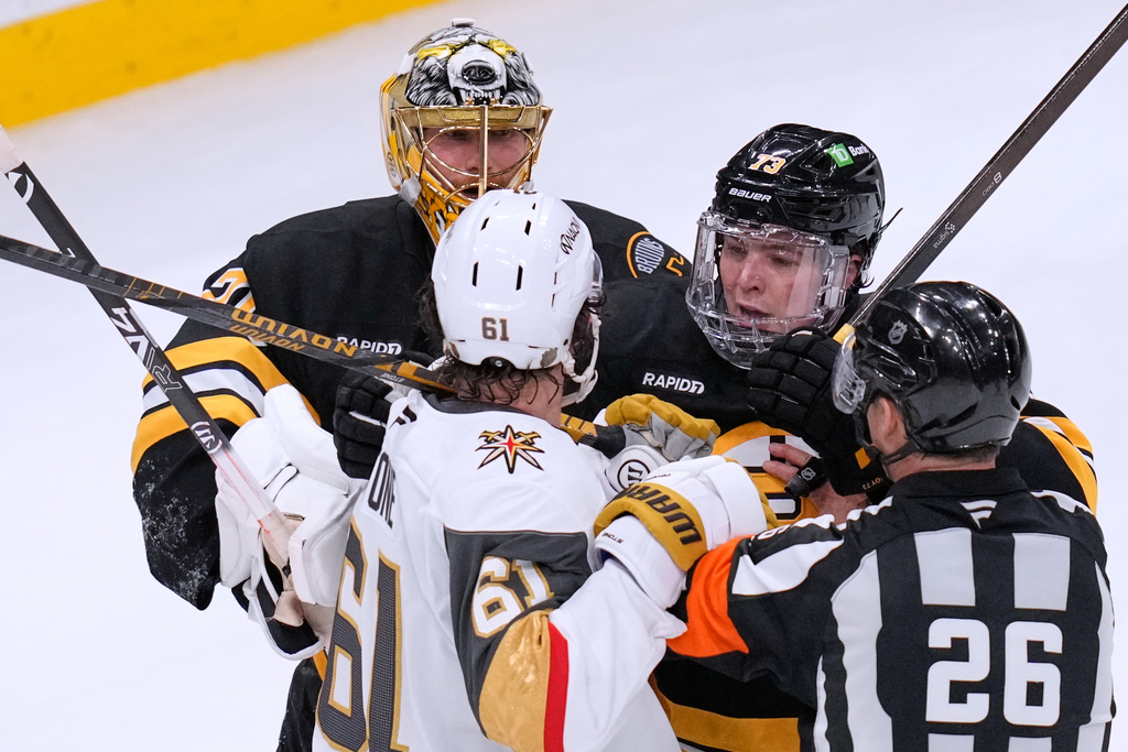 Vegas Golden Knights right wing Mark Stone (61) taunts Boston Bruins goaltender Joonas Korpisalo (70) and defenseman Charlie McAvoy (73) near the end of the third period of an NHL hockey game, Thursday, Jan. 22, 2026, in Boston. (AP Photo/Charles Krupa)