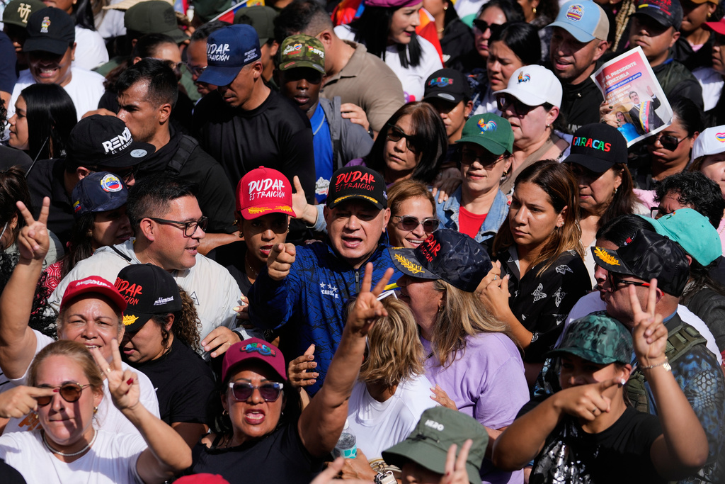 Interior Minister Diosdado Cabello, center, attends a women's march to demand the return of Venezuelan President Nicolas Maduro in Caracas, Venezuela, Tuesday, Jan. 6, 2026, three days after U.S. forces captured him and his wife. (AP Photo/Matias Delacroix)