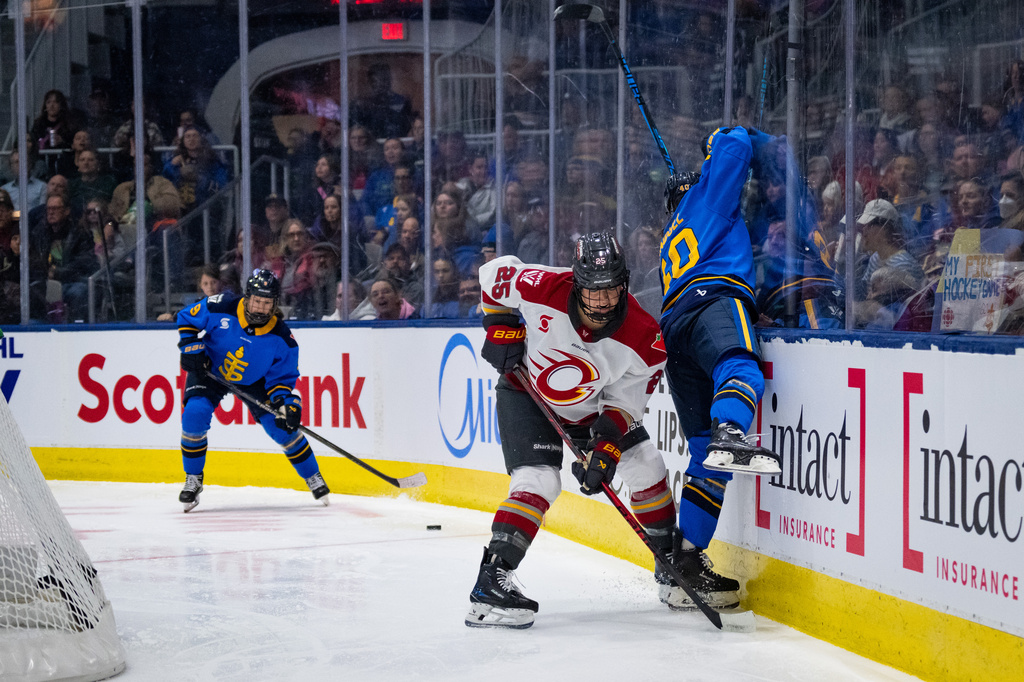 Ottawa Charge defenseman Emma Greco (25) checks Toronto Sceptres forward Blayre Turnbull (40) into the glass during second period of a PWHL hockey game in Toronto, Saturday, April 11, 2026. (Arlyn McAdorey/The Canadian Press via AP)