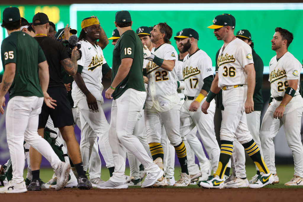 Athletics' Jeff McNeil (22) celebrates with his teammates after hitting a walk off RBI single during the ninth inning of a baseball game against the Toronto Blue Jays Monday, Sept. 7, 2026, in West Sacramento, Calif. (AP Photo/Scott Marshall)