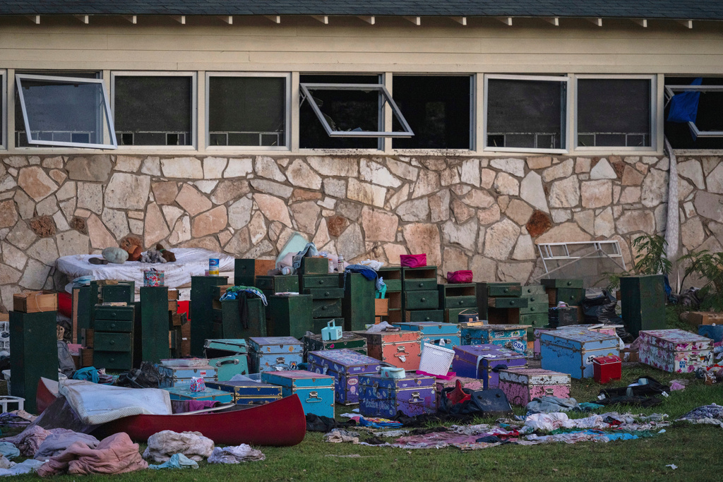 FILE - The belongings of campers sit outside one of Camp Mystic's cabins near the Guadalupe River in Hunt, Texas, July 7, 2025, after a deadly flash flood swept through the area. (AP Photo/Eli Hartman, File)