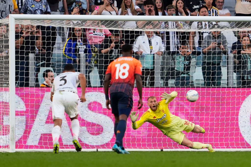 Juventus' goalkeeper Michele Di Gregorio saves a penalty kick during the Italian Serie A soccer match between Juventus and Genoa in Turin, Italy, Monday, April 6, 2026. (Fabio Ferrari/LaPresse via AP)