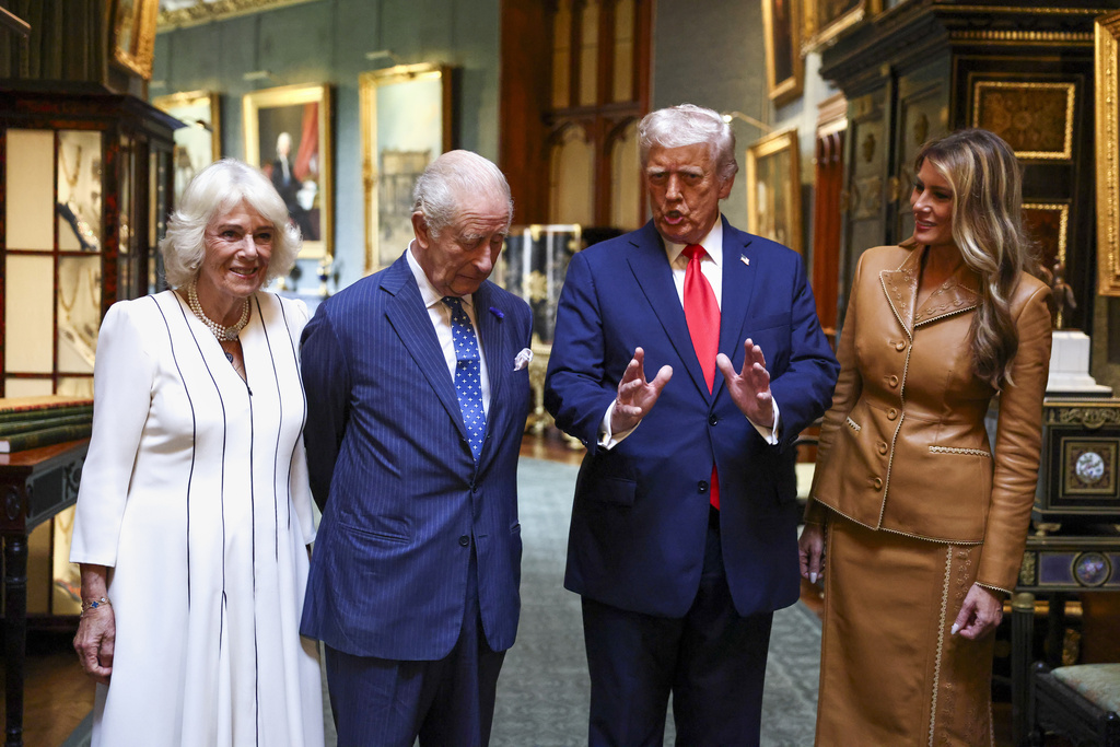 President Donald Trump speaks as he stands next to first lady Melania Trump, right, and Britain's King Charles III and Queen Camilla as they bid their farewells during Donald Trump's departure from Windsor Castle, in Windsor, England, Thursday, Sept. 18, 2025. (Kevin Lamarque/Pool Photo via AP)