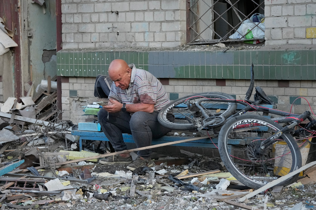 A man reacts at the site of a Russian missile strike that hit a residential building in Kyiv, Ukraine, Thursday, July 2, 2026. (AP Photo/Efrem Lukatsky)