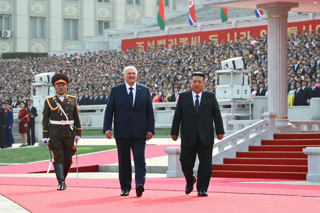 In this photo released by Belarus' Presidential Press Service, North Korea's leader Kim Jong Un, right, and Belarusian President Alexander Lukashenko, center, attend an official meeting ceremony in Pyongyang, North Korea, Wednesday, March 25, 2026. (Belarus' Presidential Press Service via AP)