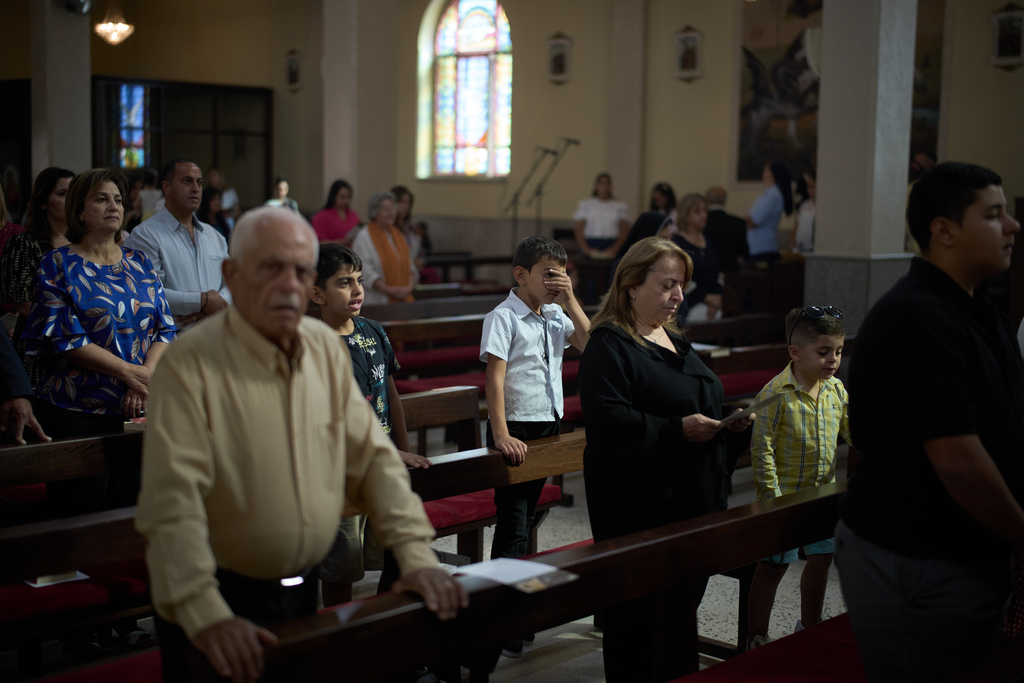 Palestinians attend morning mass at Christ the Redeemer Catholic Church in the West Bank village of Taybeh, Sept. 28, 2025. (AP Photo/Leo Correa)