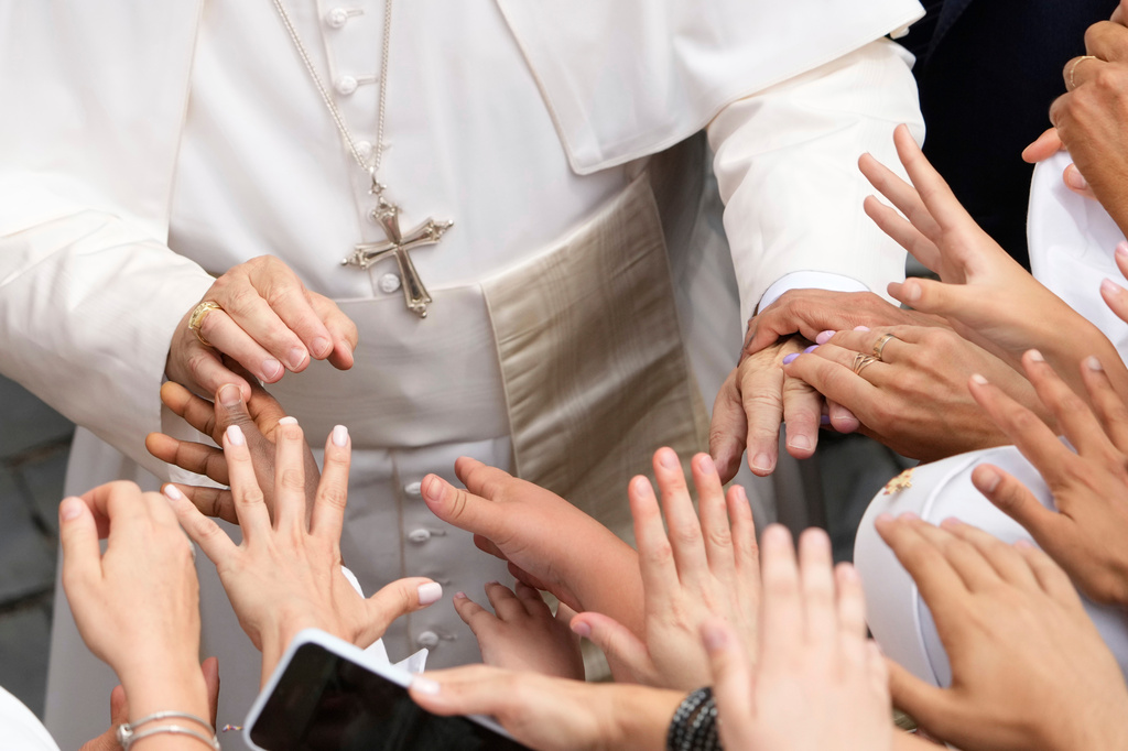 FILE - Pope Leo XIV is greeted by faithful at the end of the Angelus prayer in Castel Gandolfo, Italy, Aug.15, 2025. (AP Photo/Gregorio Borgia, File)