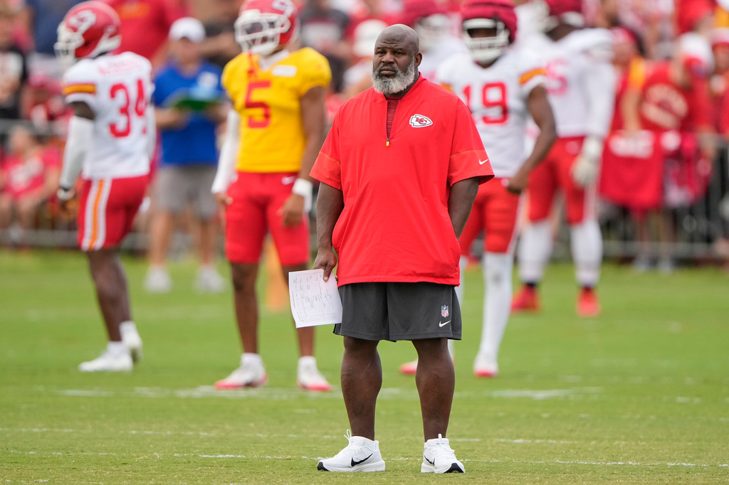 Kansas City Chiefs offensive coordinator Eric Bieniemy watches NFL football training camp Tuesday, Aug. 11, 2026, in St. Joseph, Mo. (AP Photo/Charlie Riedel)