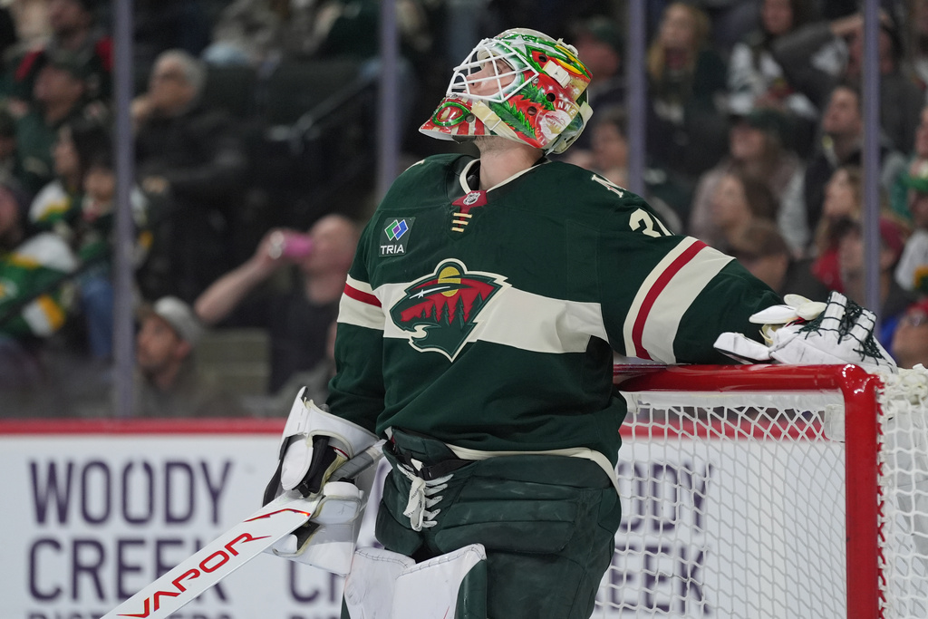 Minnesota Wild goaltender Jesper Wallstedt looks at the replay board after a goal by New Jersey Devils left wing Ondrej Palat during the second period of an NHL hockey game, Monday, Jan. 12, 2026, in St. Paul, Minn. (AP Photo/Abbie Parr)