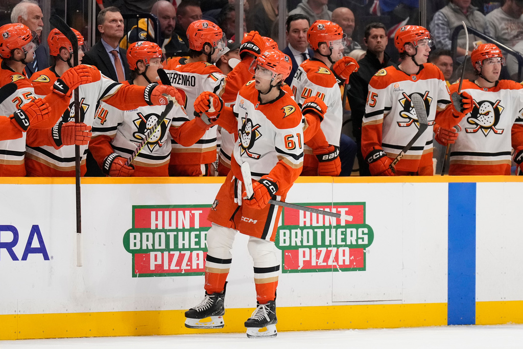 Anaheim Ducks left wing Cutter Gauthier (61) celebrates his goal with teammates during the second period of an NHL hockey game against the Nashville Predators, Tuesday, Oct. 21, 2025, in Nashville, Tenn. (AP Photo/George Walker IV)