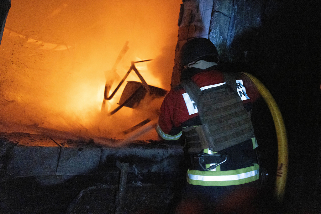 In this photo provided by the Ukrainian Emergency Service, emergency personnel work to extinguish a fire in Sumy, Ukraine, on Friday, Oct. 31, 2025, following Russian drone attacks. (Ukrainian Emergency Service via AP)