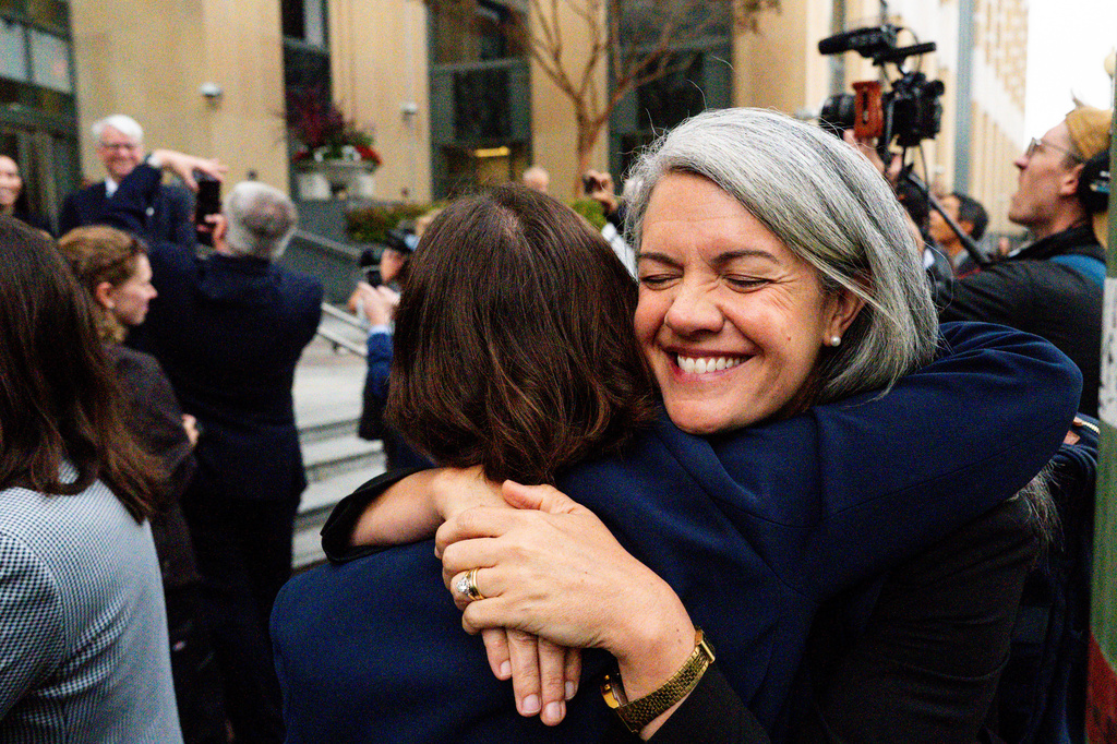 Colorado Solicitor General Shannon Stevenson, right, hugs a colleague outside of court after tech giant Meta agreed to pay $17 billion as part of a settlement to end a landmark trial over teen social media addiction in Oakland, Wednesday, Aug. 26, 2026. (AP Photo/Noah Berger)