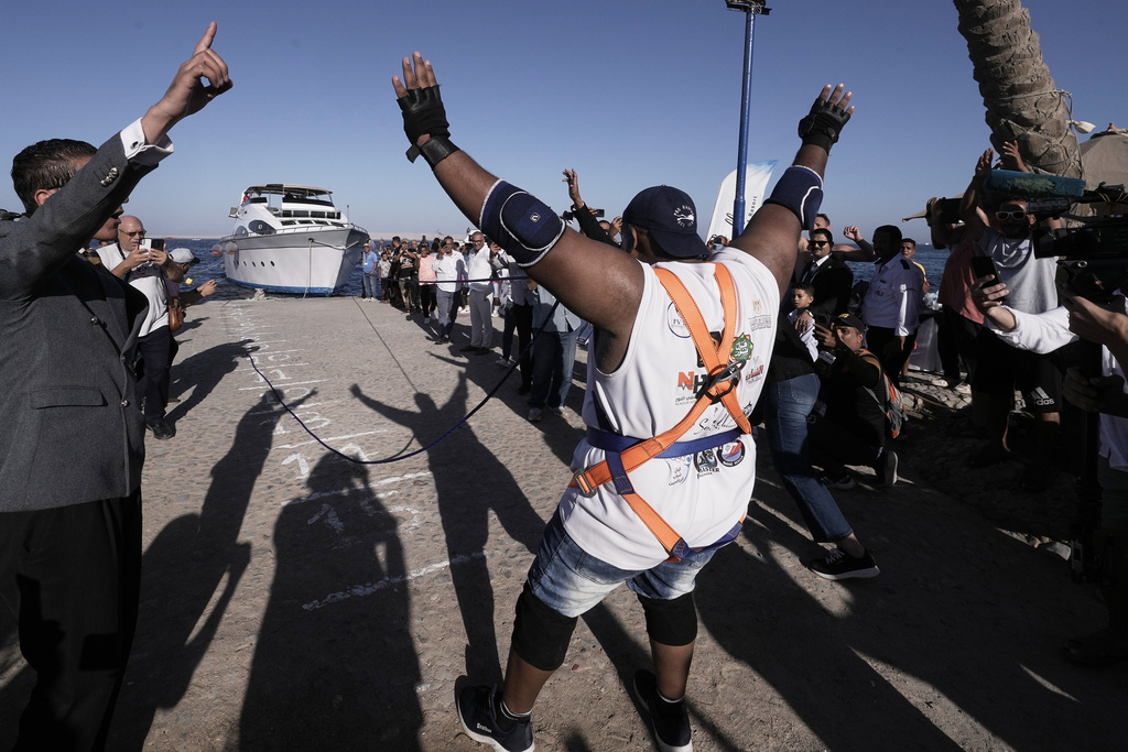 Egyptian wrestler Ashraf Mahrous, better known as Kabonga, pulls a 700-ton ship across the water with a rope held only by his teeth at the marina of the Red Sea resort of Hurghada, Egypt, Saturday, Sept. 27, 2025. (AP Photo/Amr Nabil)