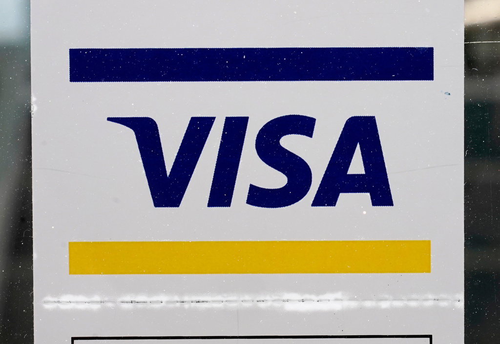 FILE -A Visa sign is displayed on the front door of a local business, April 27, 2021, in Urbandale, Iowa. (AP Photo/Charlie Neibergall, File)