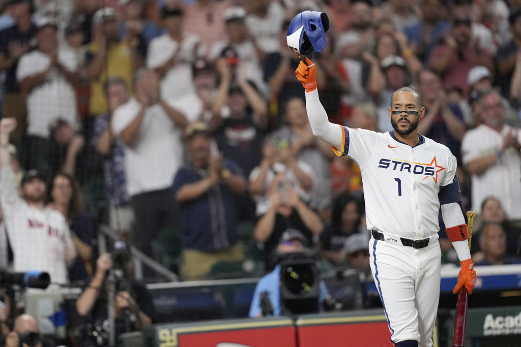 Houston Astros' Carlos Correa acknowledges the crowd as he come up to bat against the Boston Red Sox during the first inning of a baseball game Monday, Aug. 11, 2025, in Houston. (AP Photo/David J. Phillip)