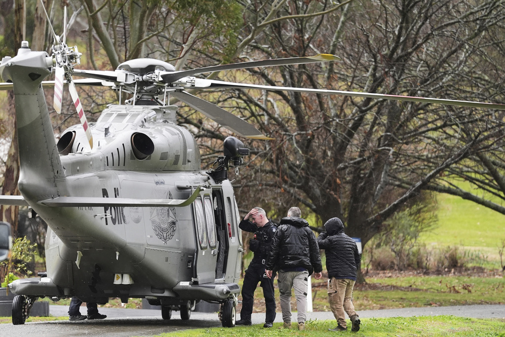 Police board a helicopter at a command area at Feathertop Winery in Porepunkah in Victoria, Australia, Wednesday, Aug. 27, 2025. (Simon Dallinger/AAP Image via AP)