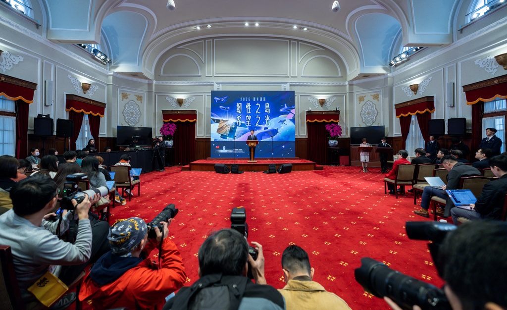 In this photo released by the Taiwan Presidential Office, journalists film Taiwanese President Lai Ching-te delivering his New Year speech at the Presidential Office, in Taipei, Taiwan, Thursday, Jan. 1, 2026. (Taiwan Presidential Office via AP)