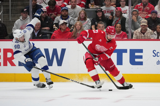 Detroit Red Wings center Dylan Larkin (71) skates past Tampa Bay Lightning defenseman J.J. Moser (90) in the second period of an NHL hockey game Friday, Oct. 17, 2025, in Detroit. (AP Photo/Paul Sancya) Detroit Red Wings center Dylan Larkin (71) skates past Tampa Bay Lightning defenseman J.J. Moser (90) in the second period of an NHL hockey game Friday, Oct. 17, 2025, in Detroit. (AP Photo/Paul Sancya)