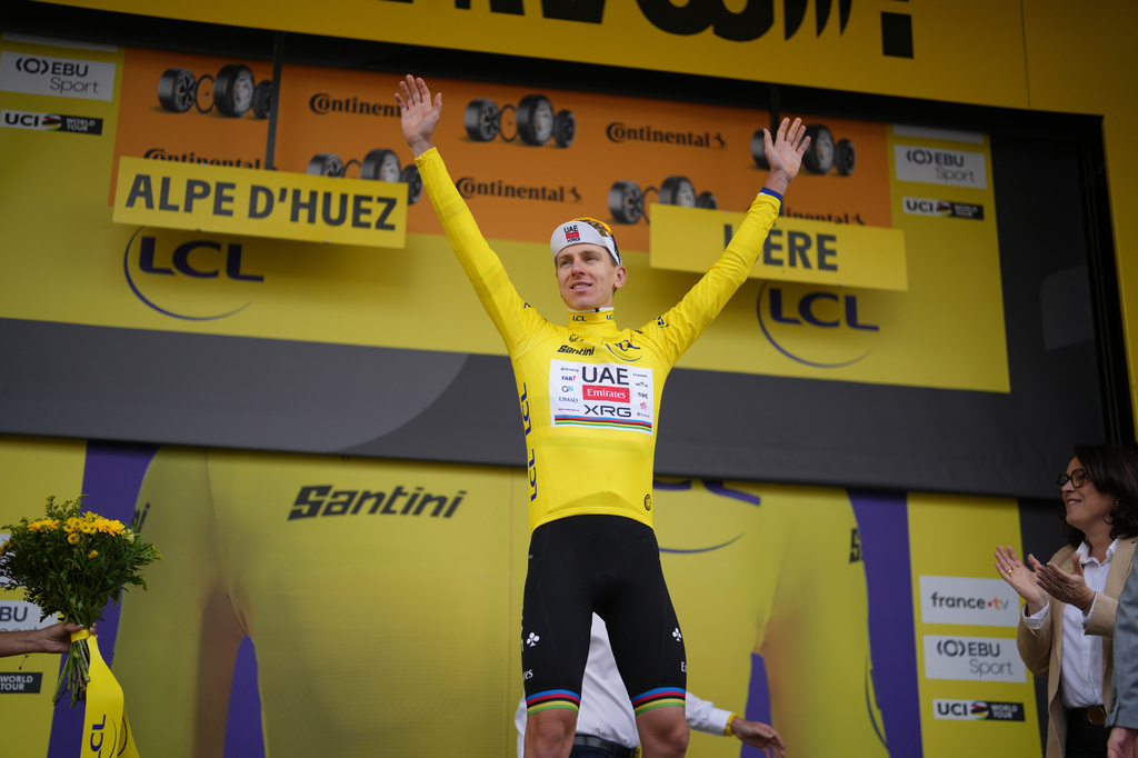 Slovenia's Tadej Pogacar, wearing the overall leader's yellow jersey, celebrates on the podium after the twentieth stage of the Tour de France cycling race with start in Le Bourg d'Oisans and finish in Alpe d'huez, France, Saturday, July 25, 2026. (AP Photo/Thibault Camus)