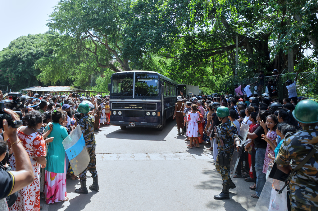 A crowd of people wait outside a prison where deadly clashes broke out on Sunday, in Negombo, 35 kilometers (22 miles) north of the capital Colombo, Sri Lanka, Monday, July 6, 2026. (AP Photo)