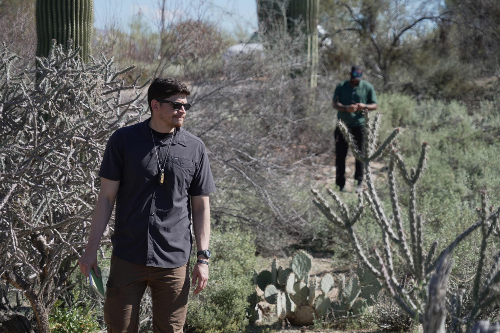 Law enforcement agents check vegetation areas around Nancy Guthrie’s home in Tucson, Ariz., Wednesday, Feb. 11, 2026. (AP Photo/Ty ONeil)