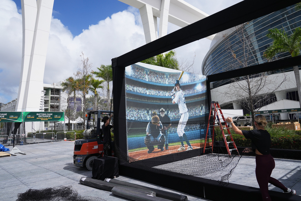 Workers construct a speed pitch game outside of loanDepot Park in advance of the World Baseball Classic, Thursday, March 5, 2026, in Miami. (AP Photo/Lynne Sladky)