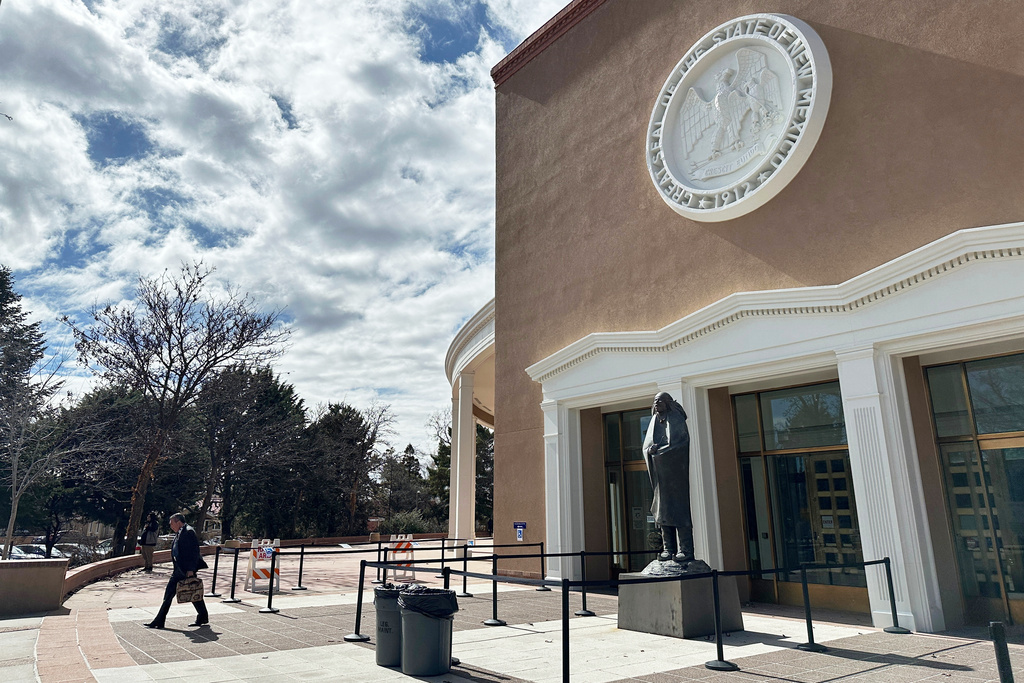 A man exits the state Capitol in Santa Fe, N.M., where state lawmakers on Tuesday, Feb. 17, 2026, launched an investigation into past activity at a secluded desert ranch where financier and sex offender Jeffrey Epstein once entertained guests, and whether local authorities looked the other way. (AP Photo/Morgan Lee)