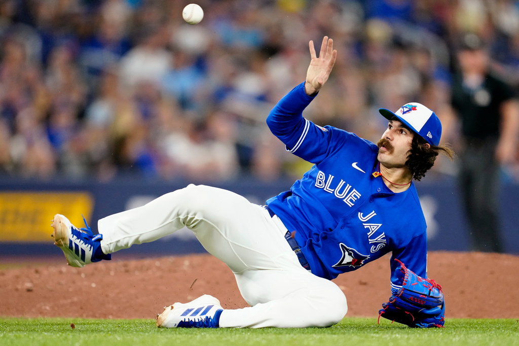 Toronto Blue Jays pitcher Dylan Cease misses the ground ball hit by Boston Red Sox's Roman Anthony as he tumbles off the mound, allowing a run to score, during fifth-inning baseball game action in Toronto, Monday, April 27, 2026. (Frank Gunn/The Canadian Press via AP)