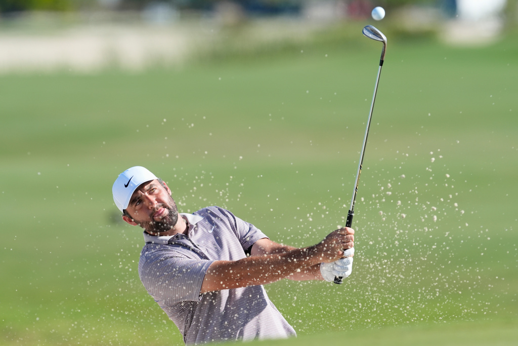 Scottie Scheffler, of the United States, hits from the bunker on the 10th hole during the final round of the Hero World Challenge PGA Tour at the Albany Golf Club, in New Providence, Bahamas, Sunday, Dec. 7, 2025. (AP Photo/Fernando Llano)