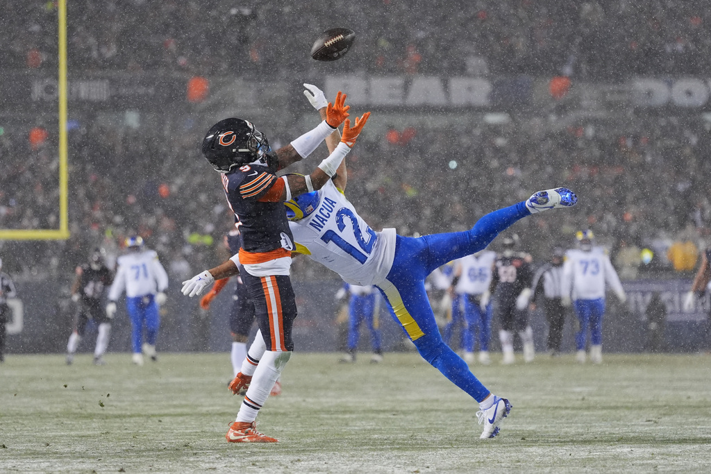 Chicago Bears safety Jaquan Brisker, left, breaks up a pass intended for Los Angeles Rams wide receiver Puka Nacua during the first half of an NFL football divisional playoff game Sunday, Jan. 18, 2026, in Chicago. (AP Photo/Jeff Roberson)