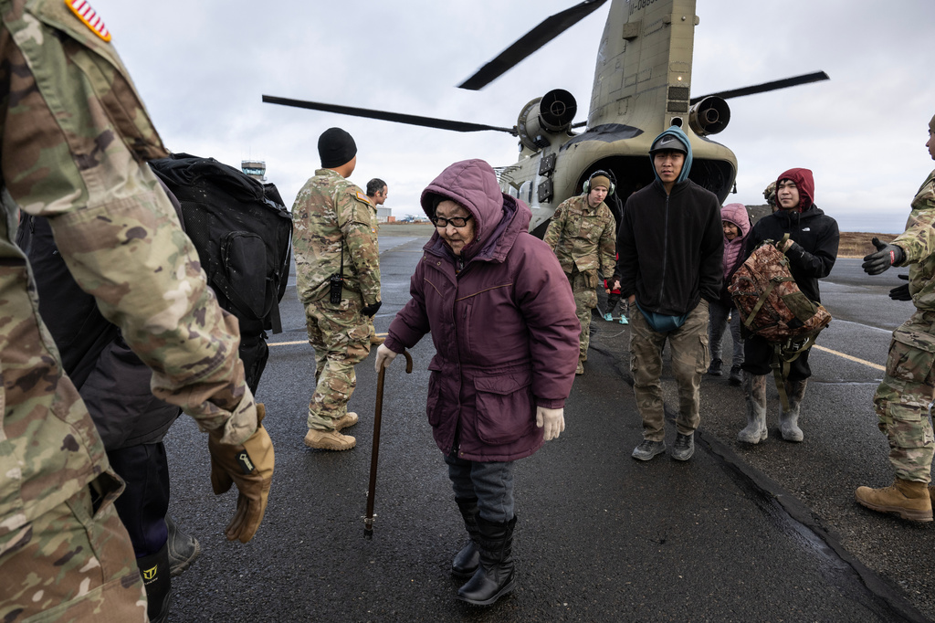 People from the village of Tuntutuliak, Alaska, arrive in Bethel, Alaska, Friday, Oct. 17, 2025, on an Alaska Army National Guard helicopter. (Marc Lester/Anchorage Daily News via AP)