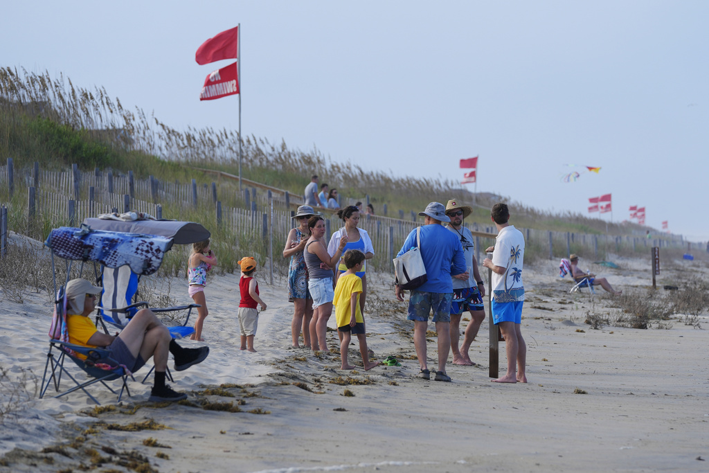 Red flags, indicating swimming is prohibited, are raised at the beach in Duck, N.C., Tuesday, Aug. 19, 2025, as precautions are taken ahead of Hurricane Erin. (AP Photo/Pablo Martinez Monsivais)