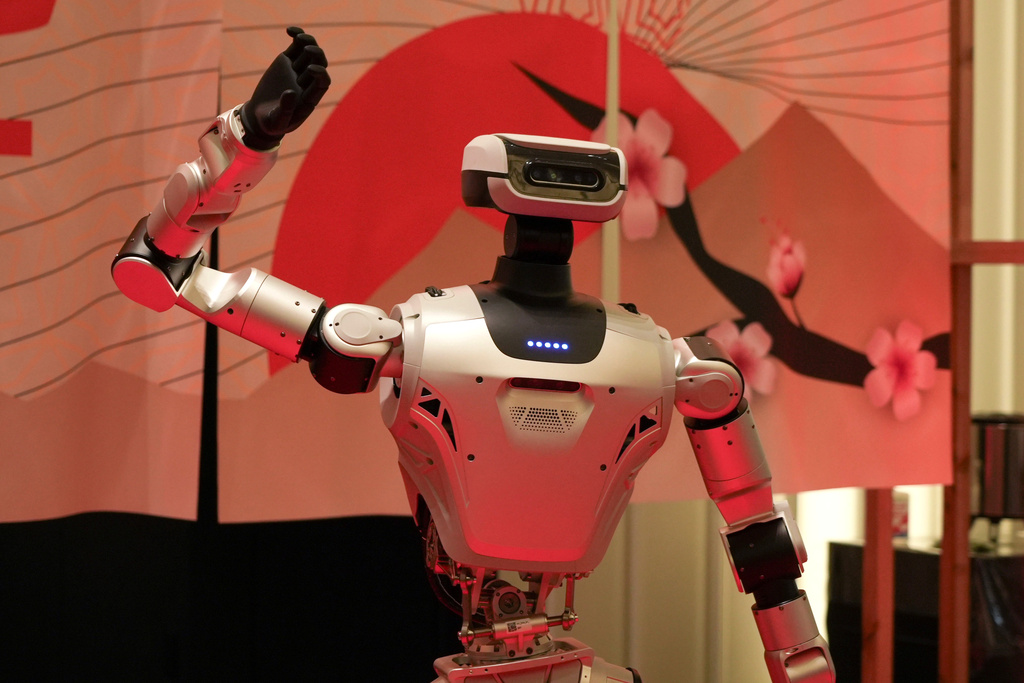 A humanoid robot poses for photo at the Humanoids Summit 2026 in Tokyo, Thursday, May 28, 2026. (AP Photo/Ayaka McGill)