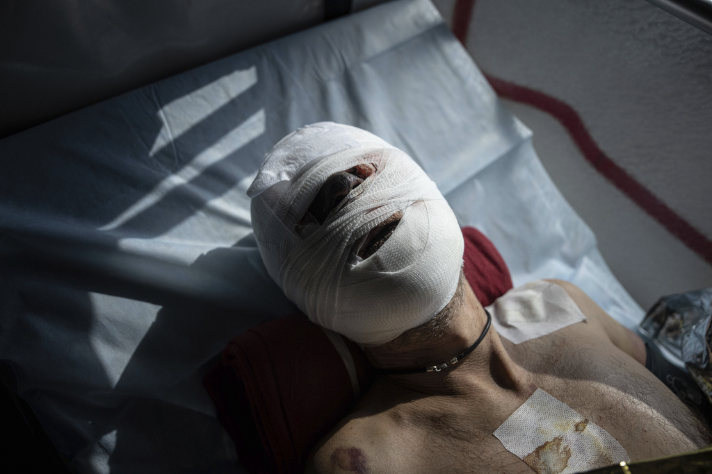 FILE - An injured Ukrainian soldier lies on a bed inside a special medical bus during an evacuation by volunteers from the Hospitallers paramedic organization in Donetsk region, Ukraine, March 22, 2023. (AP Photo/Evgeniy Maloletka, File)