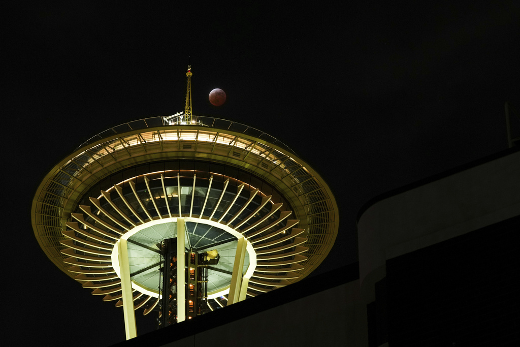 FILE - A total lunar eclipse is seen over the Space Needle, Thursday, March 13, 2025, in Seattle. (AP Photo/Lindsey Wasson, File)