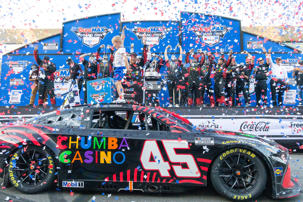 23XI Racing's Tyler Reddick, front right, celebrates with his son Beau Reddick, front left, after winning a NASCAR Cup Series auto race in Austin, Texas, Sunday, March 1, 2026. (AP Photo/Stephen Spillman)