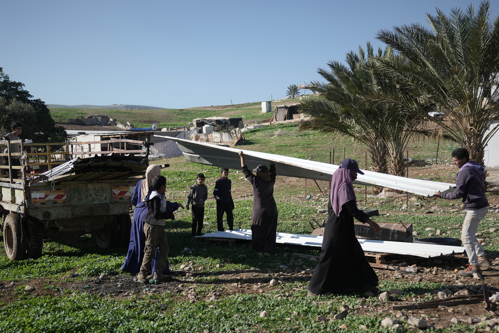 Palestinian residents of Ras Ein al-Auja village, West Bank pack up their belongings and prepare to leave their homes after deciding to flee mounting settler violence, Sunday, Jan. 11, 2026. (AP Photo/Mahmoud Illean)