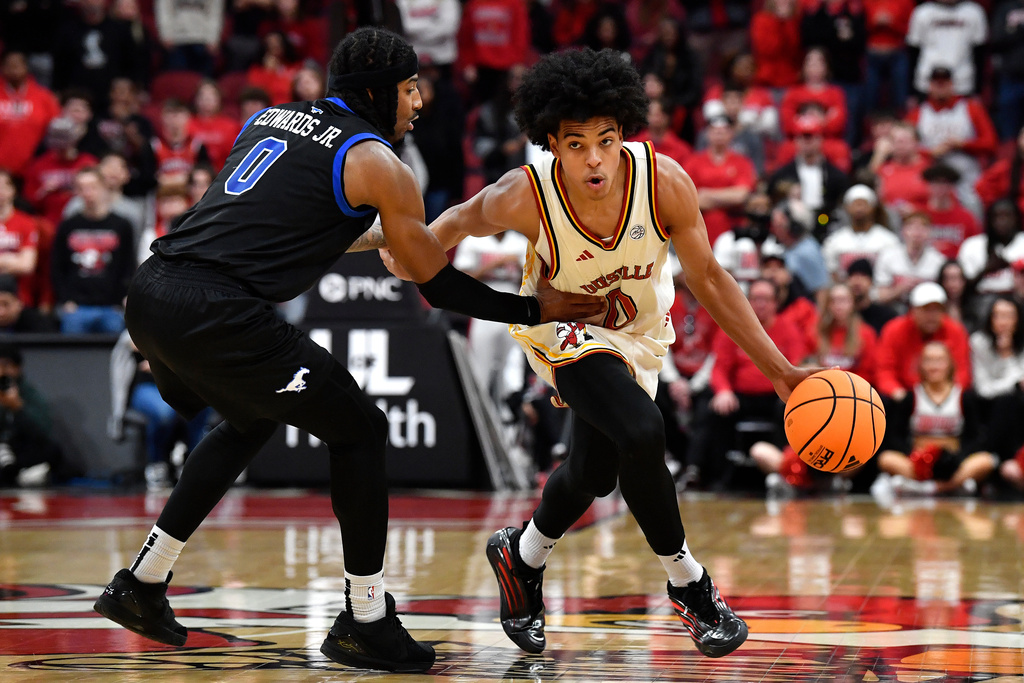 Louisville guard Mikel Brown Jr. (0) drives against SMU guard B.J. Edwards (0) during the second half of an NCAA college basketball game in Louisville, Ky., Saturday, Jan. 31, 2026. (AP Photo/Timothy D. Easley)