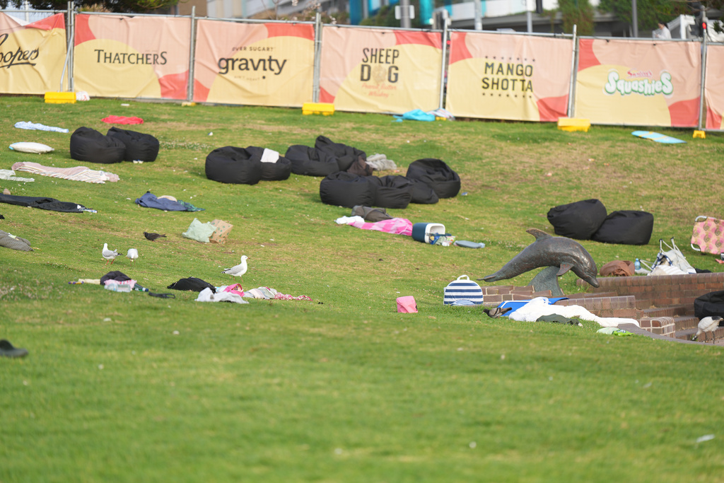 Personal belongings are left on a grassy area in the early morning following a shooting Sunday at Sydney's Bondi Beach, Monday, Dec. 15, 2025. (AP Photo/Mark Baker)