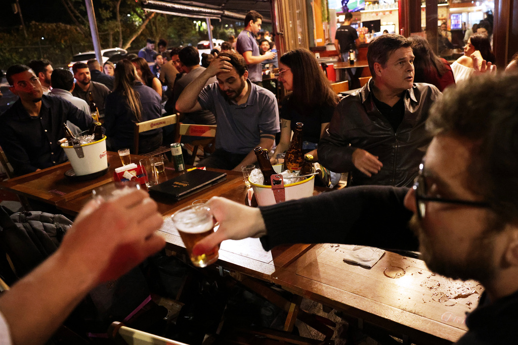 People drink beer at a bar in Sao Paulo, Friday, Oct. 3, 2025. (AP Photo/Ettore Chiereguini)