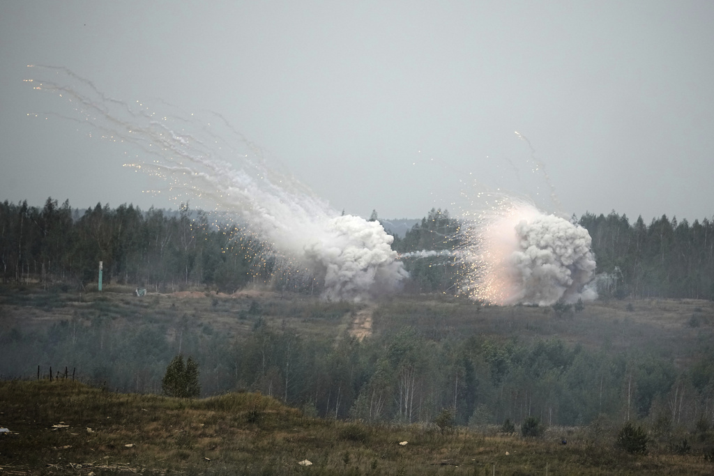 Explosions are seen during joint Russian-Belarusian military drills at a training ground near Barysaw, Belarus, Monday, Sept. 15, 2025. (AP Photo/Pavel Bednyakov)
